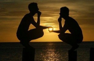 2 men appearing to hold the sun